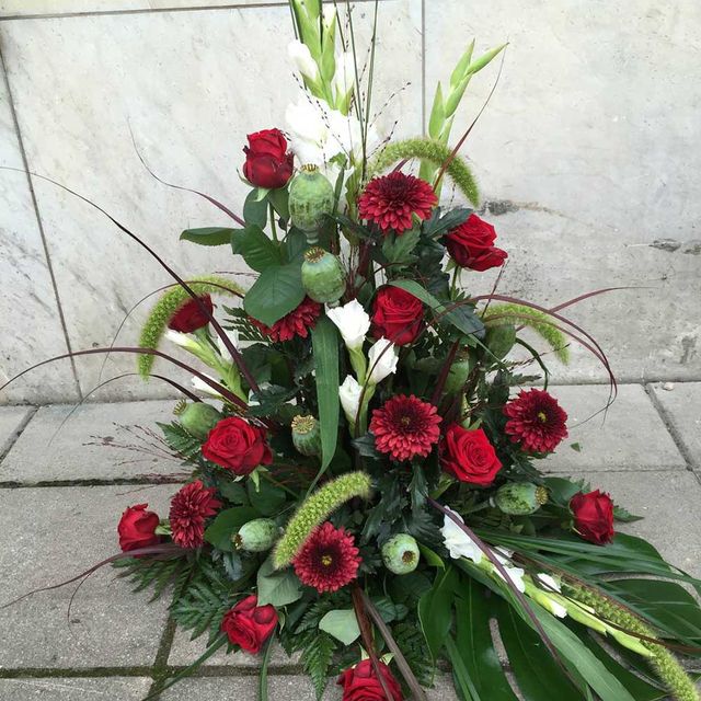 Röda rosor, vita nejlikor, röda blommor till begravning